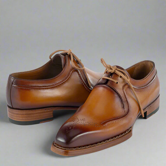 Pair of brown leather dress shoes on a white background