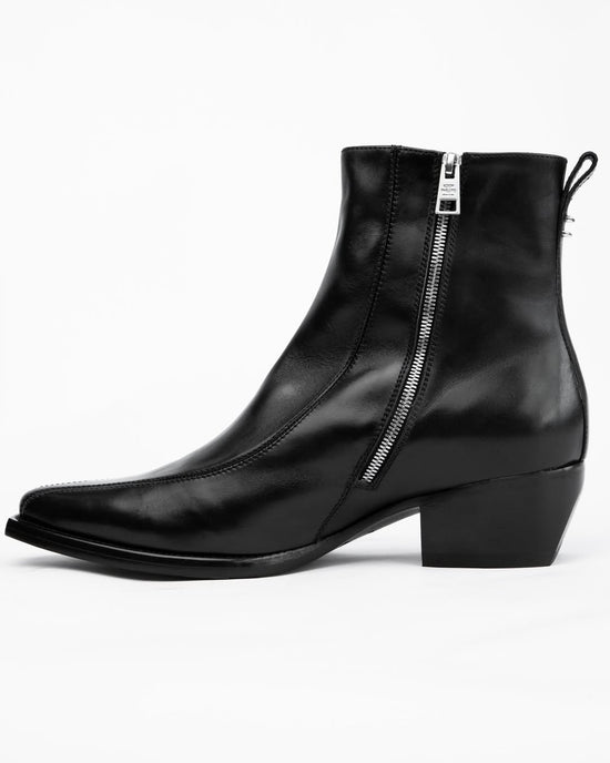 A black leather ankle boot with a side zipper, low block heel, and pull tab, shown from a side profile on a white background.