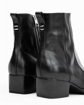 Black leather ankle boots with a side zipper and block heel, shown from a rear three-quarter angle on a white background.