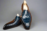 Pair of navy blue dress shoes on a wooden surface