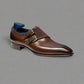 Brown leather dress shoe with gold buckle on a white background