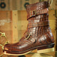 A brown embossed leather ankle boot with multiple buckle straps, shown standing on its beige sole against a rustic wooden background.