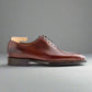Brown leather dress shoe on a white background