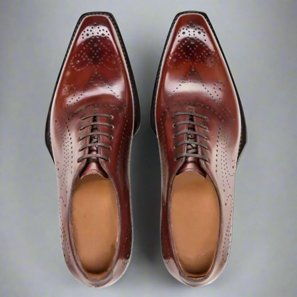 Pair of brown dress shoes on a white background