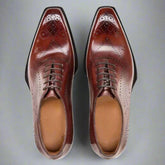 Pair of brown dress shoes on a white background
