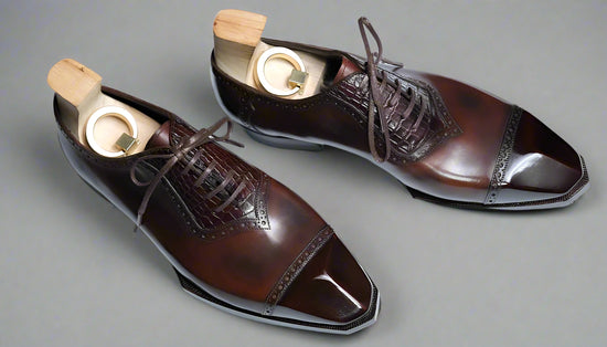 Brown dress shoes with wooden soles on a white surface