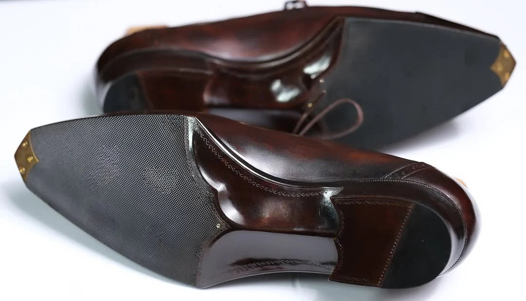 Pair of brown leather shoes on a white background