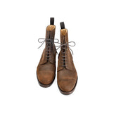 Pair of brown leather boots on a white background