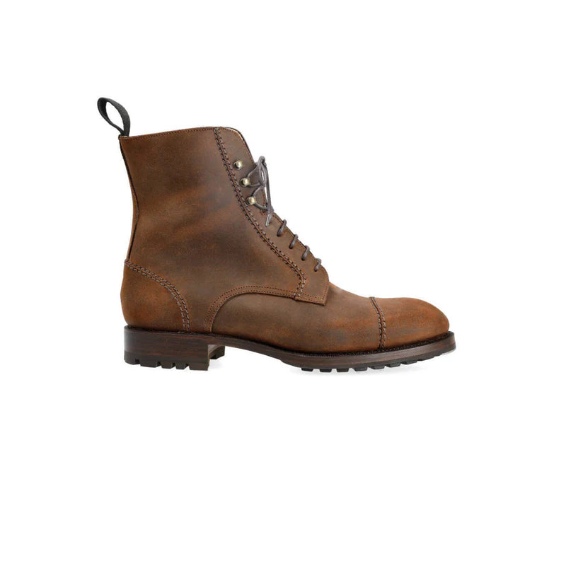Brown leather boot on a white background