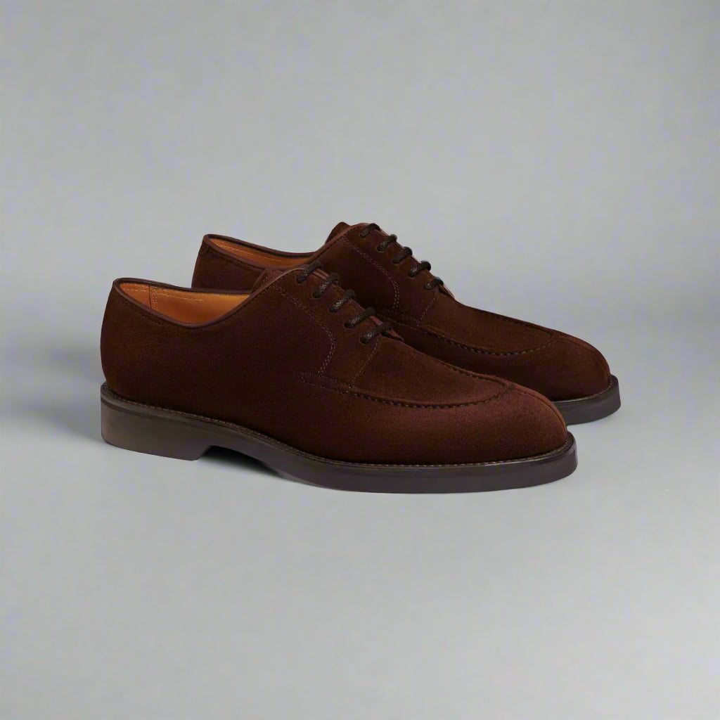 Pair of brown suede dress shoes on a white background