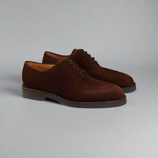 Pair of brown suede dress shoes on a white background