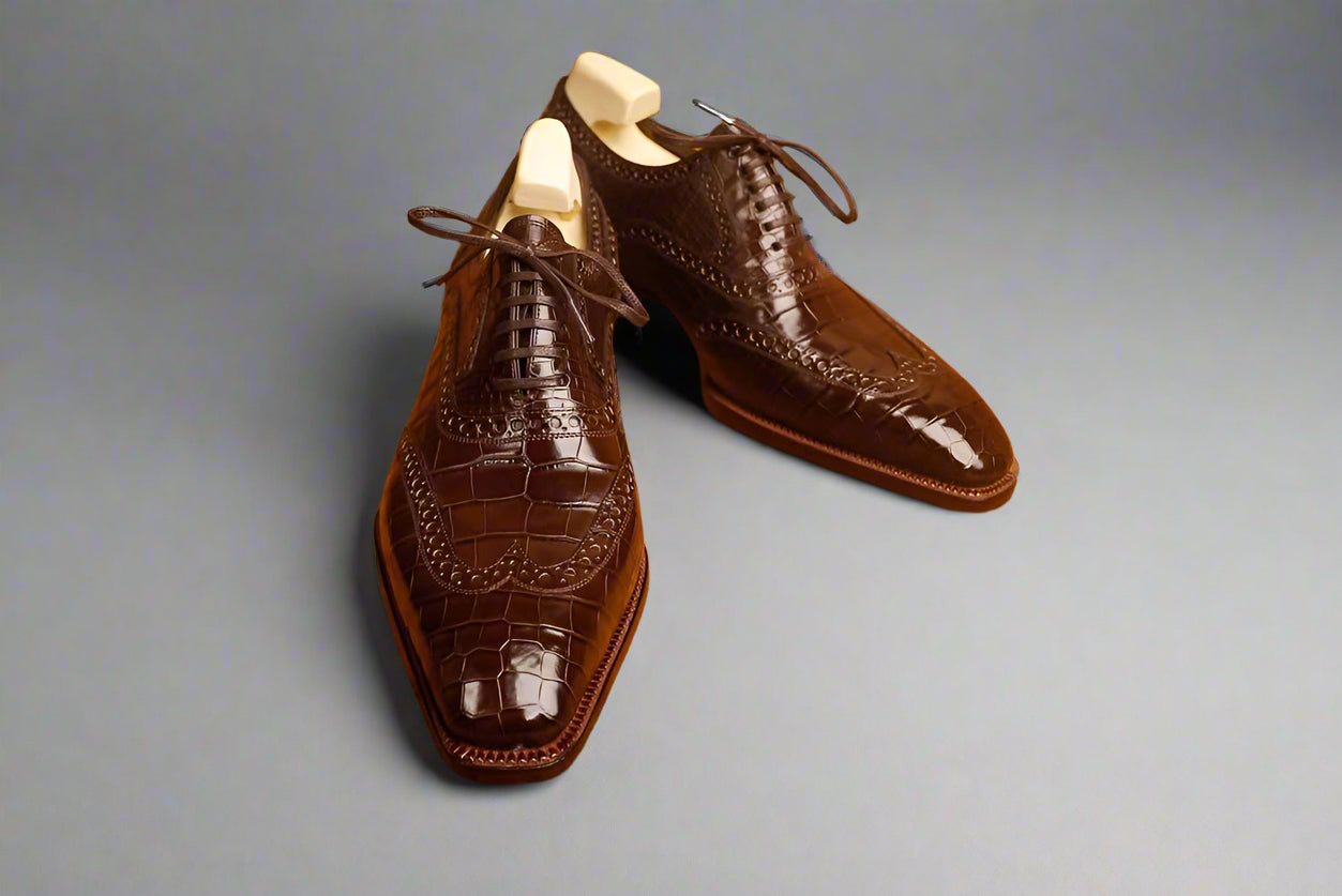 Brown leather dress shoes on a wooden surface