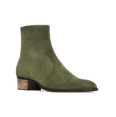 Green suede ankle boot on a white background