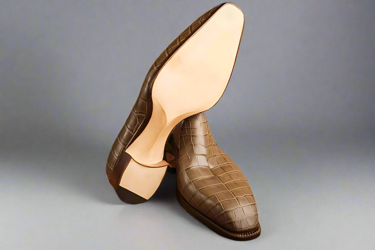 Brown textured shoes on a wooden surface
