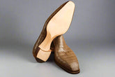 Brown textured shoes on a wooden surface