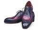 A pair of men's wingtip oxford shoes with a glossy gradient finish transitioning from deep navy blue to rich purple. The shoes feature classic brogue detailing, matching navy laces, and are photographed on a clean white background.
