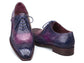 A pair of men's wingtip oxford shoes with a glossy purple and navy blue gradient finish, featuring dark brown soles and matching blue laces, shown against a plain white background.