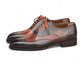 A pair of men's wingtip oxford shoes featuring a dark brown and reddish-brown brogue design with contrasting orange laces, shown on a plain white background.