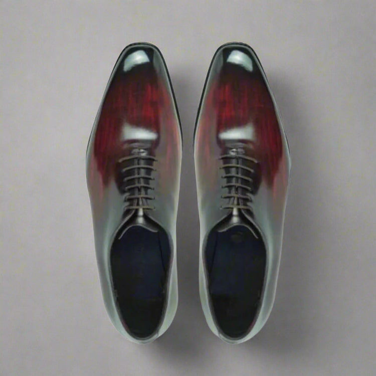 Pair of polished dress shoes on a white background