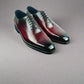 Pair of polished dress shoes on a blue box with a white background