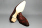 Red and brown dress shoes on a wooden surface