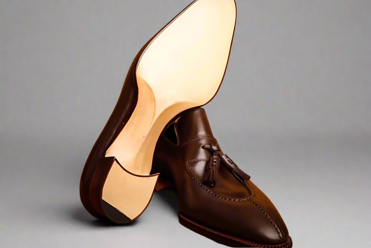 Brown leather shoes with a wooden background