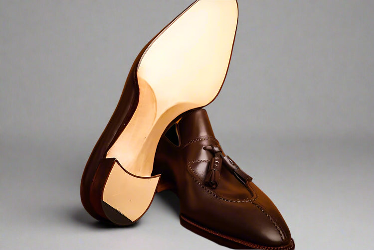 Brown leather shoes with a wooden background