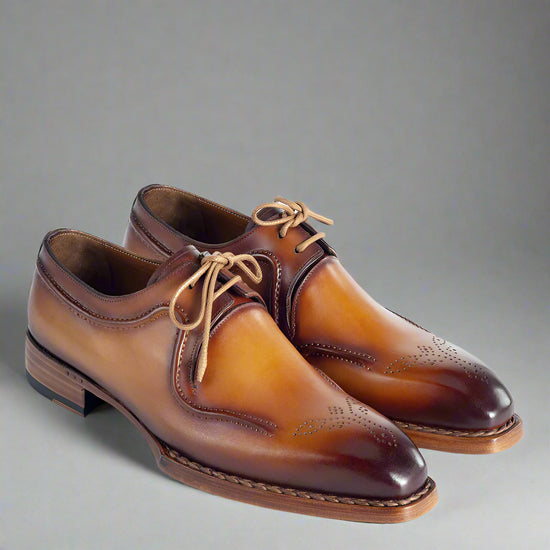 Pair of brown leather dress shoes on a white background