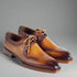 Pair of brown leather dress shoes on a white background