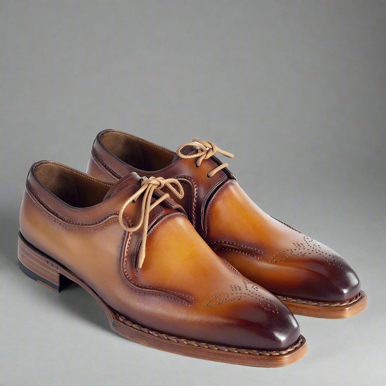 Pair of brown leather dress shoes on a white background