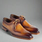 Pair of brown leather dress shoes on a white background