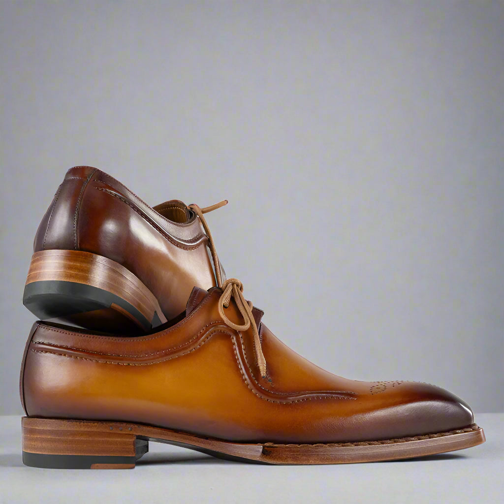 Pair of brown leather dress shoes on a white background