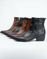 Four leather ankle boots with pointed toes and low block heels, arranged in a row on a light gray background. The boots come in black and brown colorways, with silver-tone hardware details on the front.